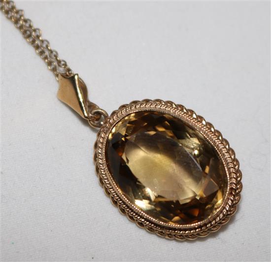 A 9ct gold and oval citrine pendant, on a 9ct gold chain, pendant 1in.